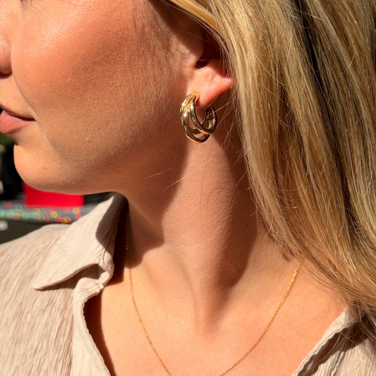 triple hoop gold earrings by sydetwelve, worn on pretty model